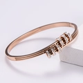Detail of rose gold slide bracelet with five sparkling crystal-encrusted rings - Rose Gold Bangle / Rose Gold
