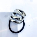 Minimalist black elastic hair tie featuring a polished silver spiral metal buckle - Style H / Silver