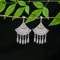 Macro shot of silver ethnic fan-shaped earrings with tassel charms hanging on a green branch - E4990-3 (Fan Tassel)