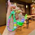 Detail of creative StellaLou bubble tea keychain with quicksand and green liquid charms - Green StellaLou Milk Tea Cup