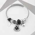 Silver charm bracelet featuring black beads and flower pendant on twisted rope chain - C2-005 Black