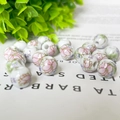 Macro shot of 10mm round white ceramic beads with floral patterns for jewelry making - 10mm / Light Floral