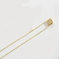 Close-up of golden necklace featuring a cubic pendant with crystal-studded letter C detail - Letter C (XL3420)