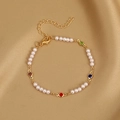 Chic gold pearl bracelet with colorful gemstones on a champagne silk background - Colorful Pearl Bracelet