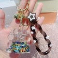 Luminous quicksand castle keychain with brown star lanyard and golden bell accent - Castle Black