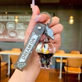 Close-up of astronaut dog keychain with liquid globe and 'DREAM ON' silicone strap - Black Gold Astronaut Moon