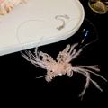 Detailed macro view of pink feather butterfly pendant with crystal beads on clear wire - Butterfly Necklace (HN8286) / Pink