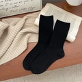 Classic black ribbed knit crew socks displayed on a vintage desk with autumn accessories - One Size / Black