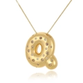 Detailed macro shot of 18k gold plated letter Q pendant with cubic zirconia stones - Letter Q
