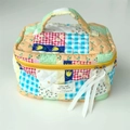 Detail of colorful patchwork quilted cosmetic bag with ribbon zipper pull and brand tag - Patchwork Grid Flower