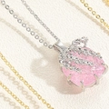 Macro shot of pink heart zircon pendant with silver leaf branch design on white leather - Plant Branch Claw Setting Pendant / Pink Platinum Plated