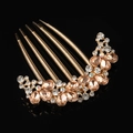 Golden hair comb with champagne crystals and floral design on black background - Champagne