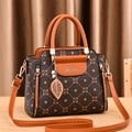 Women's handbag in dark floral print and brown leather with metal leaf charm and strap - Coffee & Ochre