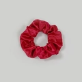 Close-up of bright red satin scrunchie showing soft pleated texture and silky sheen - Satin 27 (True Red)