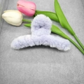 Detail shot of a large light purple plush hair claw clip with fluffy winter texture - Purple