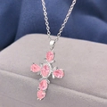 Close-up of silver cross necklace with pink pear-shaped cubic zirconia crystals - Steel Color - Pink Zirconia