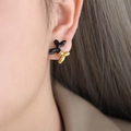 Chic balloon dog stud earrings in black enamel and gold plated finish on model - Black/Gold