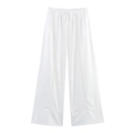 Detail of white linen wide-leg pants with drawstring waist and hollow out embroidery - XS / Pants / White
