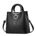 Professional studio shot of a black floral embossed bucket handbag with metal ring handle - Black