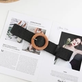 Detail of black woven belt featuring a round wood-texture buckle and leather-wrapped tip - Round Buckle Black