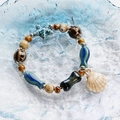 Ceramic beaded bracelet with blue starfish and seashell charms on a glazed plate - Ocean Shell and Fish Style (1615-02) / Blue and Beige Mix