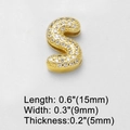 Macro shot of gold letter S charm with white cubic zirconia pavé setting detail - S