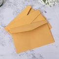 Three premium brown kraft paper envelopes stacked neatly on a clean flat surface - Kraft Envelope / 15.5x10.5cm