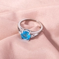 Detailed view of silver ring with blue center stone on soft pink silk fabric background - Adjustable Open / Blue Gemstone/Silver Band