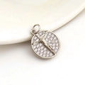 Micro shot of a silver crucifix pendant with crystal halo and religious engraving - Silver Plated Copper/Zirconia