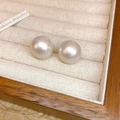 Macro shot of high-luster white round pearl earrings on a beige velvet jewelry display - 31# Silver Earring Post - White - Pearl Stud - 15mm