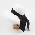 Elegant white straw sun hat with wide brim and large black satin bow ribbon for women - Adjustable / White