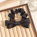 Elegant black satin ribbon scrunchie with large double bow on a display tray - Black Bow
