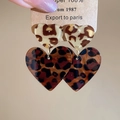 Close-up of leopard print heart-shaped resin earrings on a vintage display card - Double Layer Heart Style (Silver Needle-Coffee-Heart)