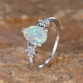 Elegant pear-shaped opal ring with side diamonds on textured stone surface background - US 5 / Platinum Multi-color