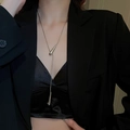 Macro detail of silver teardrop pendant and snake chain on a black suit blazer - No.12 Snake Waterdrop Style / Silver