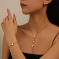 Detail of 18k gold plated stainless steel jewelry set with white heart pendants on a model - Oil Pressed Heart Jewelry Set (C611-T104-H214)