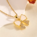 Macro shot of gold bow necklace with pink shell inlay and sparkling white zircons - Gold White Shell Inlaid Diamond Bowknot Necklace