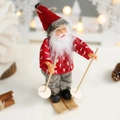 Skiing Santa Claus doll with red sweater and wooden skis on a warm snowy background - Red Heart Skiing