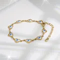 Close-up of golden heart-shaped evil eye bracelet with adjustable lobster clasp - White Eye
