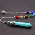 Detailed view of turquoise chakra pendant with silver hollow base and colorful beads - Turquoise