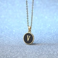 Golden round pendant necklace with black enamel inlay and letter V on blue background - Letter V
