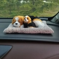 Realistic plush dog figurines on a gray mat displayed on a car dashboard ornament - Beagle Parent-Child Sitting Set