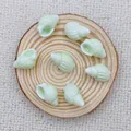 Detailed view of mint green spiral seashell ceramic beads for handmade DIY jewelry crafting - Light Water Green