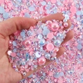 Close-up of hand holding mixed pastel resin pearls and rhinestones for DIY nail art - 30 g / Pink Light Blue Series-04