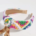 Close-up of handmade knitted floral headband showing colorful crochet texture and pattern - Deep Colorful Triangle Knotted