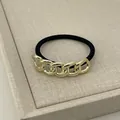 Elastic black hair tie featuring a vintage gold metal chain link decoration - 5-Link Chain Gold