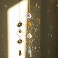 Golden suncatcher crystal pendant with sphere and teardrop prism reflecting rainbows - Design No.3