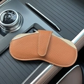 Minimalist brown lychee leather car glasses case with white stitching on car console - Earthy Yellow