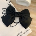 Elegant large black satin bow hair clip placed on a decorative beige canvas bag - Hair Tie / Black