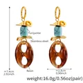 Detalle de pendientes ovalados de resina con acentos de turquesa y metal dorado - Estilo Turquesa Azul Dorado (TXF309)